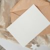 a white piece of paper sitting on top of a piece of brown paper